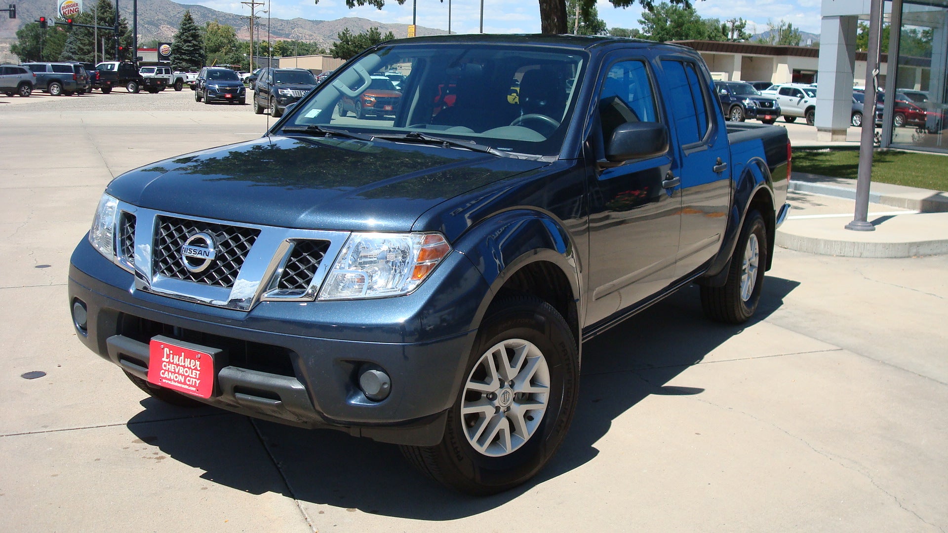 2021 Nissan Frontier SV in Blue — front three-quarter view